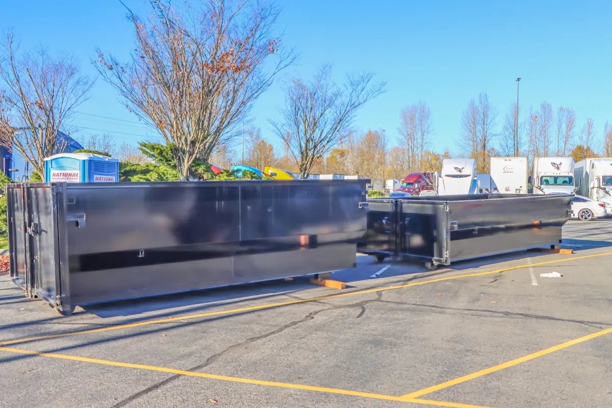 Professional dumpster rental service with roll-off container on residential driveway in Cleburne